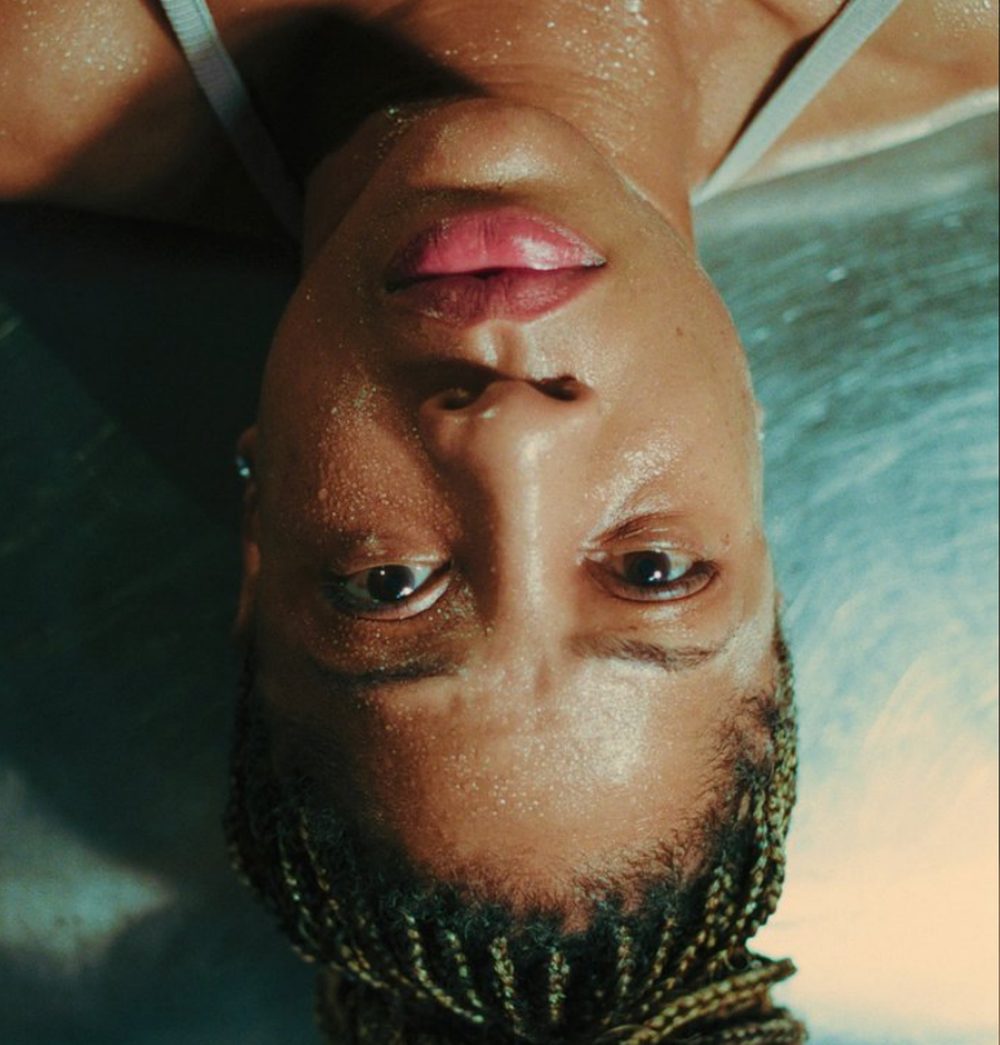 A woman floats face-up in a pool, shot upside down