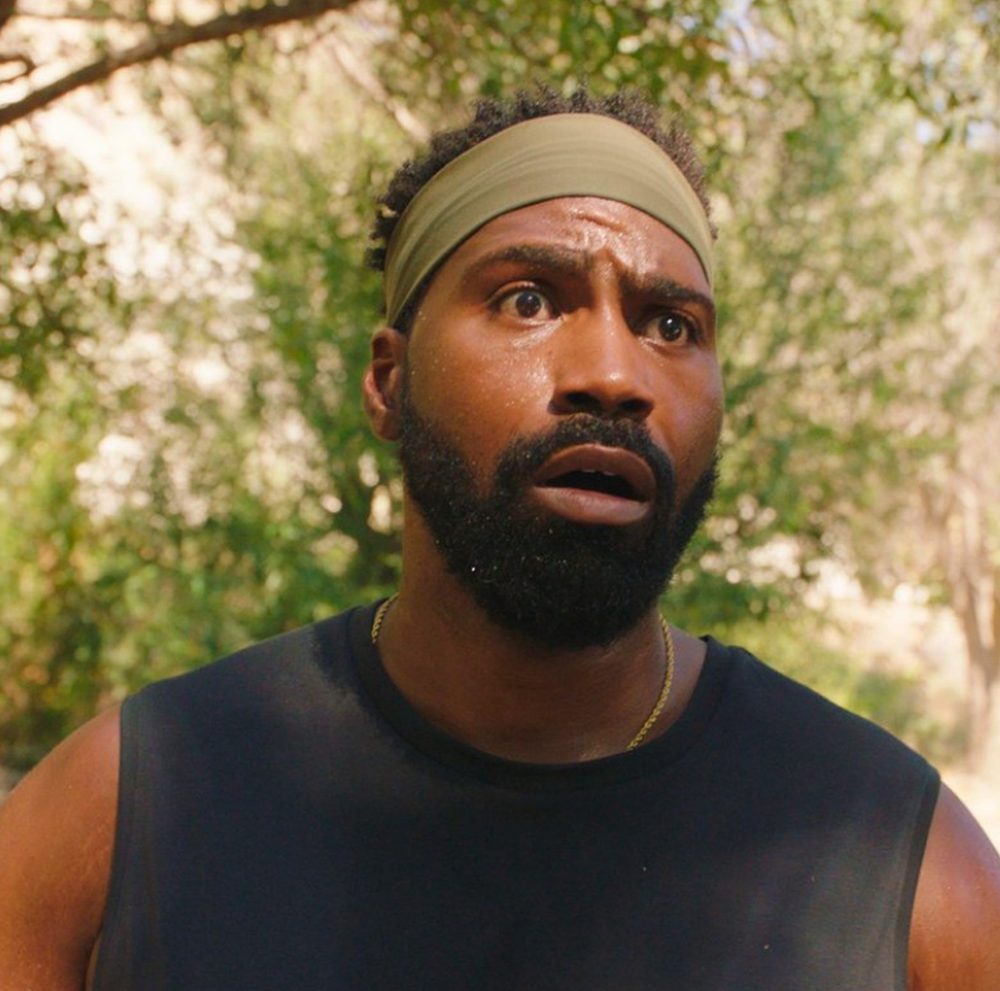 Rome, wide-eyed, wearing a headband under the trees